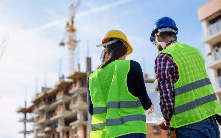 Two people working on a construction site